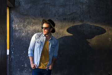 Hipster young man outdoors, posing with great attitude