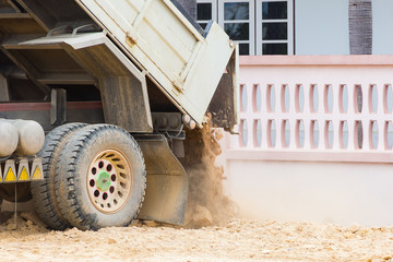 Dump truck dumps its load of rock and soil