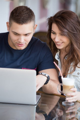 Couple with laptop at a cafe