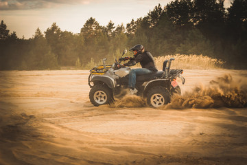 Racing ATV is sand.