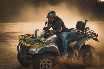 Racing ATV is sand.
