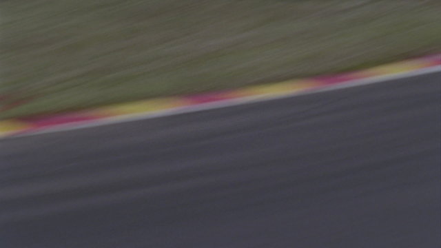 A formula car drives on a circuit track.