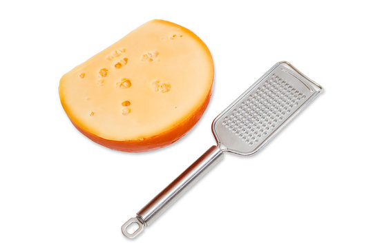 Piece of cheese and cheese grated on a light background