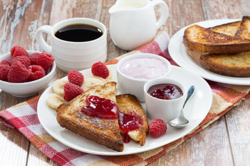 sweet toasts with raspberry, jam and yoghurt for breakfast