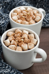 Two cups of cocoa with marshmallows, vertical, closeup