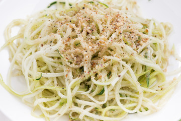 Vegetarian pasta with zucchini and nuts, closeup