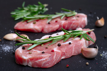 fresh raw meat with rosemary and pepper