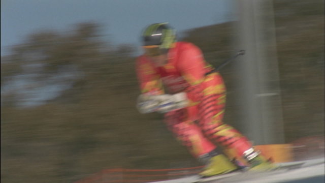 A skier skis down a slope.