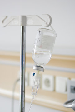 Intravenous drip or perfusion recipient administrated in a hospital room