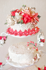 Wedding cake with red flowers.