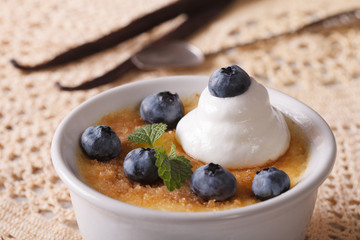 Gourmet dessert cream brulee with blueberries closeup. horizontal
