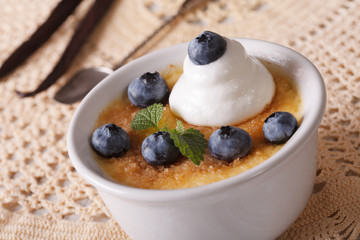French vanilla cream caramel dessert with blueberries close-up
