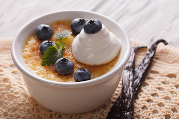 French dessert cream brulee with blueberries close-up. horizontal
