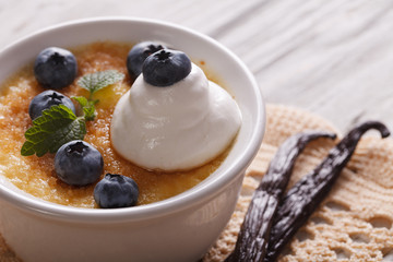 Delicious dessert cream brulee with blueberries close-up. horizontal

