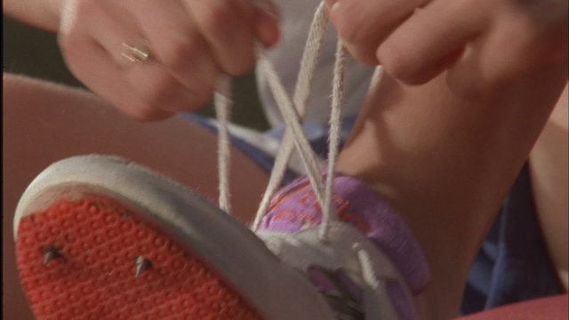 A jumper laces her shoes.