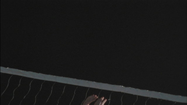 A volleyball player blocks a spike.