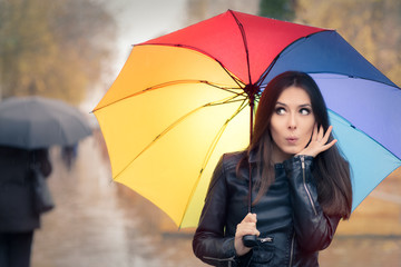 Surprised Autumn Woman Holding Rainbow Umbrella 