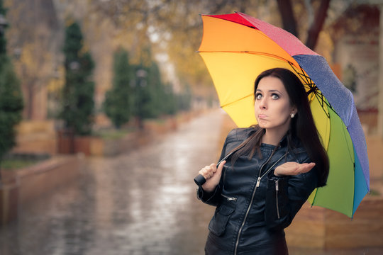 Disappointed Autumn Girl Holding Rainbow Umbrella 