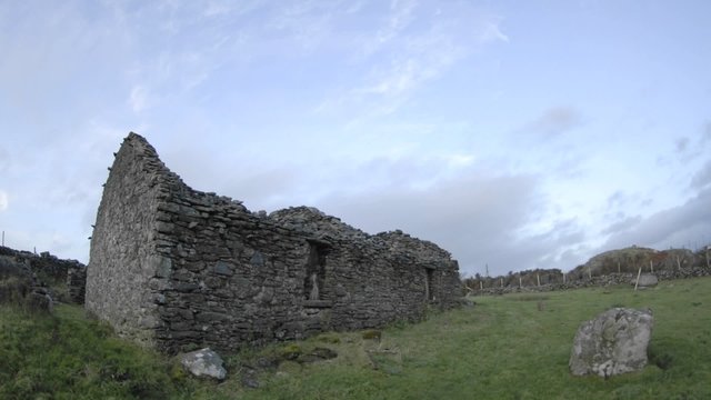 Panning time lapse of clouds blowing over the ruins in Glencolumbkille, County Donegal, Ireland.