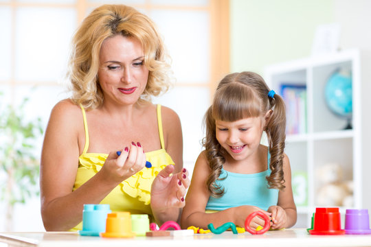 mother and child have fun with colorful play clay toys