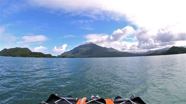 Point of view from a zodiac bow moving slow across the water with mountain views near Puerto Raul Marin Balmaceda in Southern Chile.