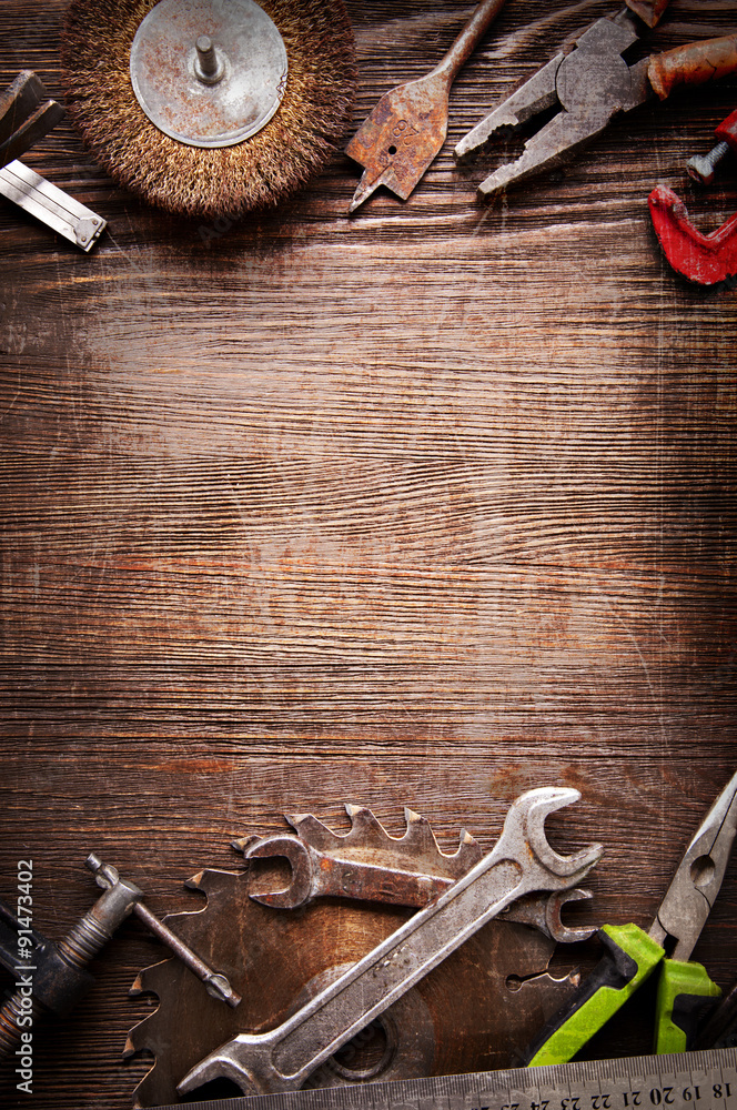 Poster grungy old tools on a wooden background