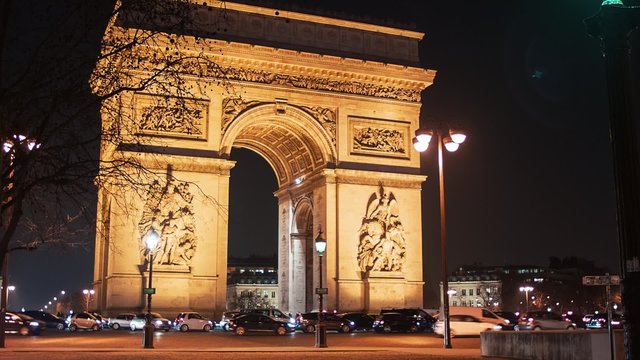 Arch Of Triumph by Night 5, Paris: A view of the Arch of Triumph (Arc de Triomphe) by night, with cars and buses passing by.