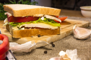 Sandwich with meat, cheese and vegetables