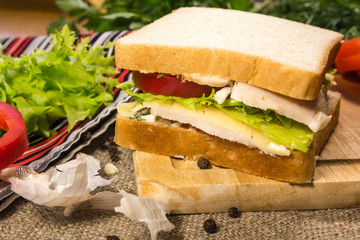 Sandwich with meat, cheese and vegetables