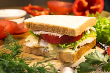 Sandwich with meat, cheese and vegetables