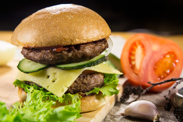 Beef burger with cheese and vegetables