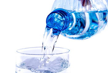 Water poured from a plastic bottle into a glass