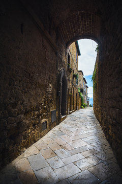 Passage under the walls of Italian village in Tuscany, Pienza