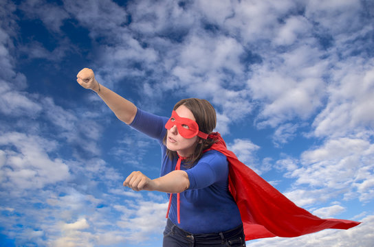 Woman superhero with red cape.