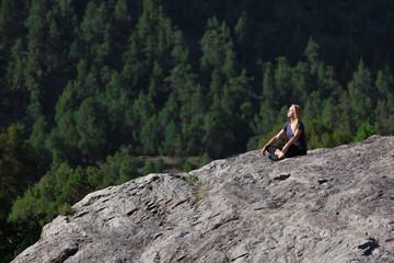 Young woman Sitting in Buddhist Zen Pose Attractive Female Athlete Sitting in Yoga Mediation Pose...