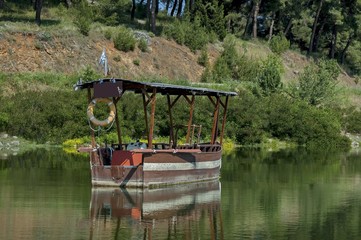 Wooden old traditional greek boat with cover in Kerkini lake