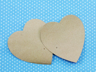 valentine day concept brown paper heart on blue polka dot backgound