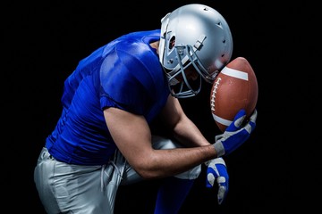 Upset American football player with ball © WavebreakMediaMicro