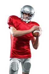 Confident American football player in red jersey holding ball