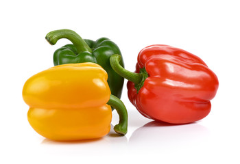 colored peppers over white background