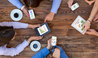 Business Team Interaction Top View of Arms of Group Young Business People Discussing Data on...