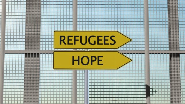 Refugees / Hope Signpost on border fence