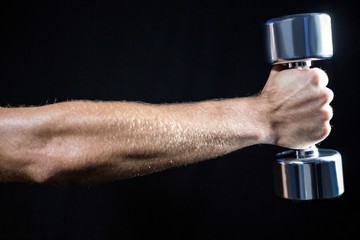 Cropped image of man working out with dumbbell