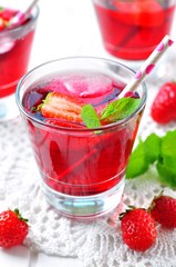 homemade strawberry compote with fresh berries, mint and ice cubes