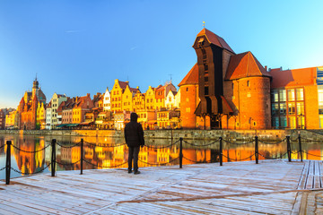 Fototapeta premium Man wearing black warm dawn jacket standing in full length on
