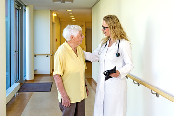 Doctor Talking to Elderly at the Hospital Corridor.