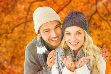 Composite image of attractive couple in winter