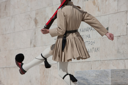 Guard goose stepping at the monument of Unknown soldier, wearing summer outfit. Syntagma square, Parliament, Athens, Greece.