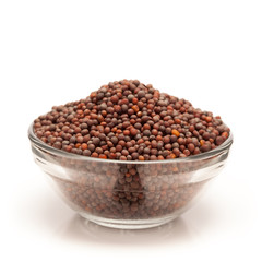 Front view of Organic brown mustard (Brassica juncea) in glass bowl isolated on white background.