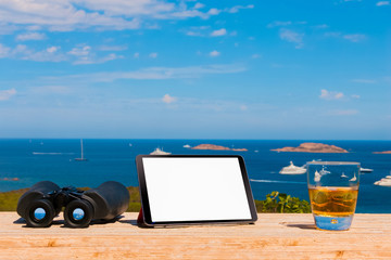 Laptop computer on wood table with sea background